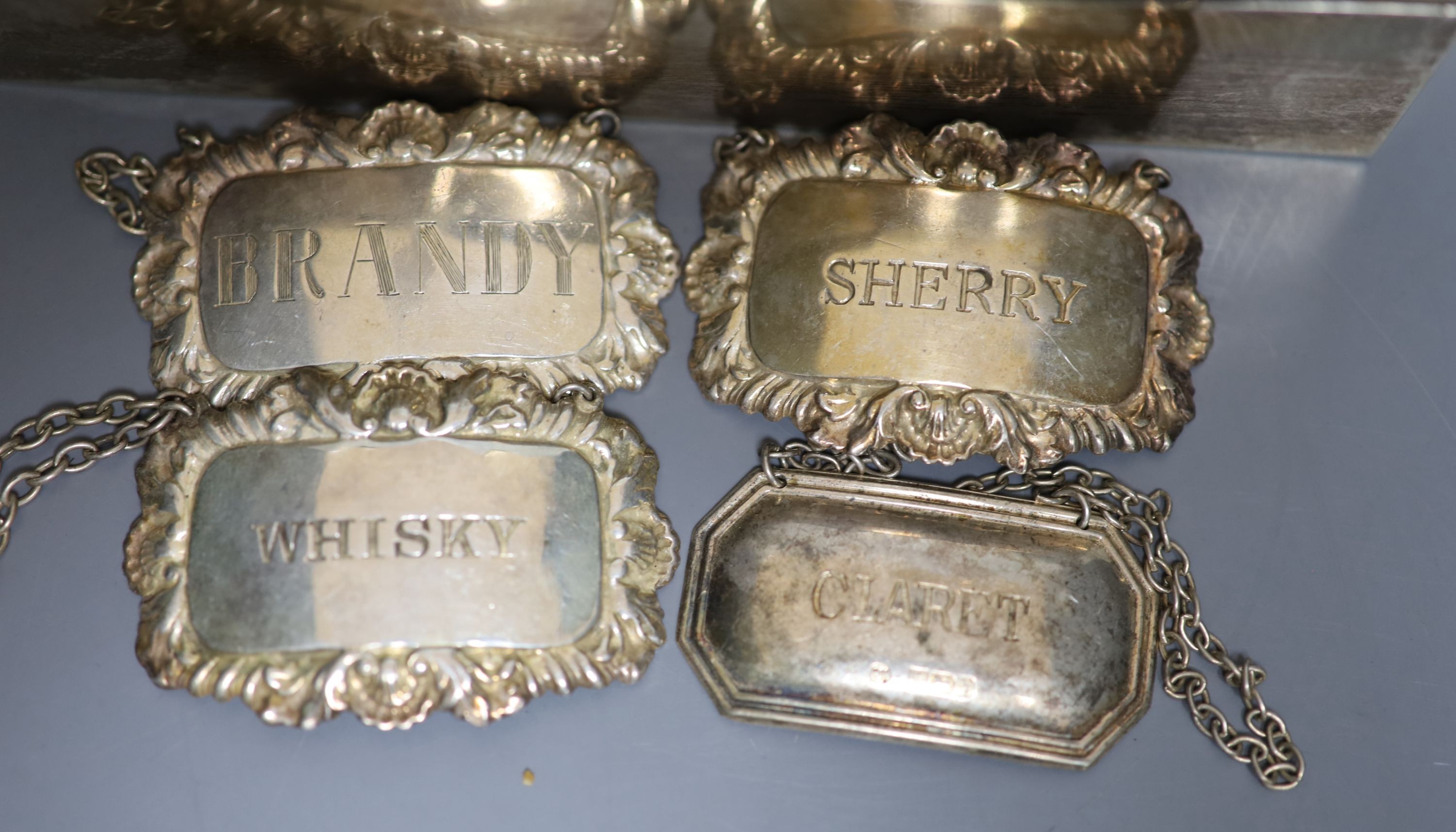 A pair of Edwardian silver vases, Birmingham, 1908, 11.1cm, weighted, four modern silver wine labels and a silver mounted cigarette box.